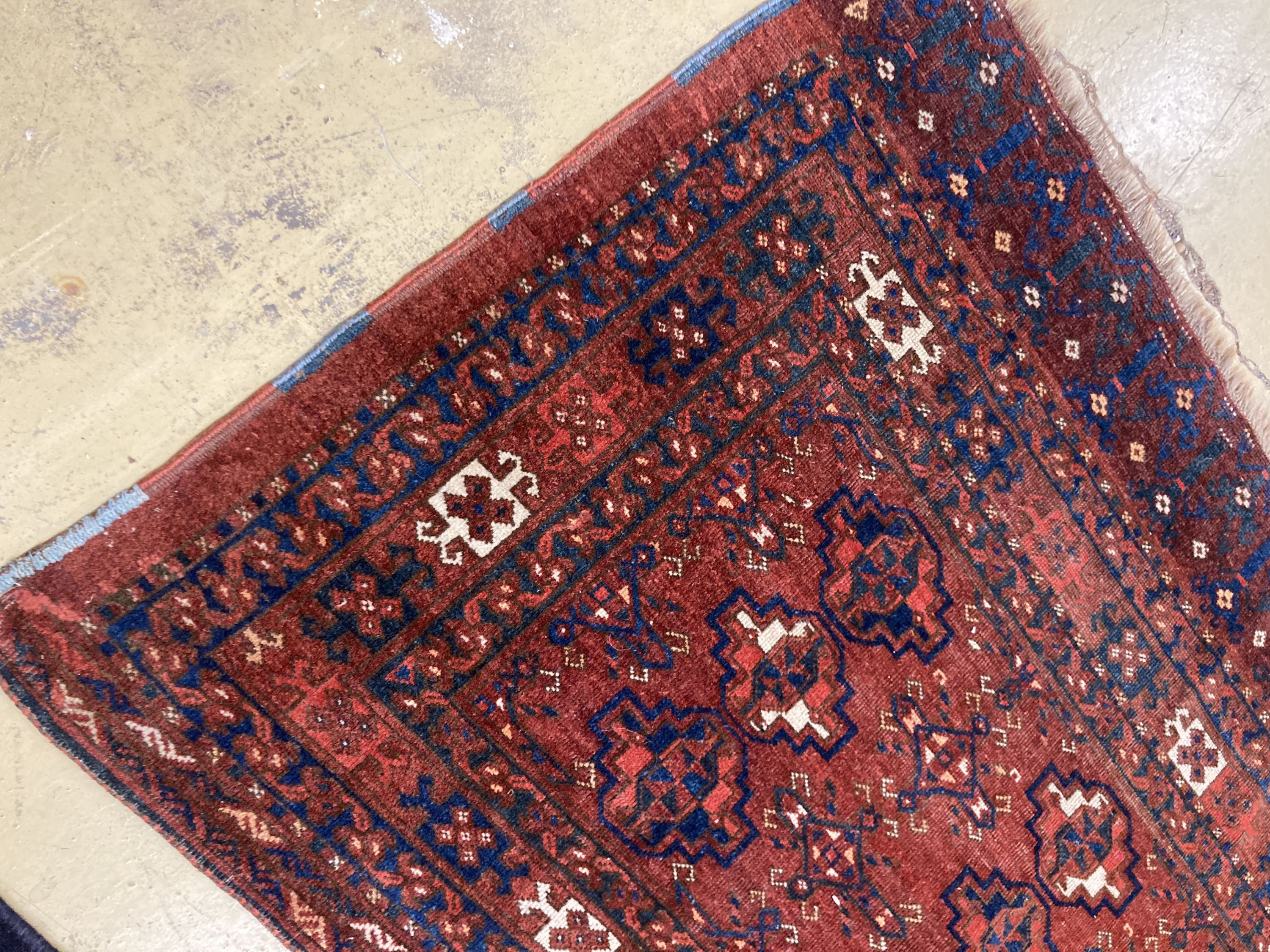 An antique Tekke burgundy ground rug, 150 x 92cm